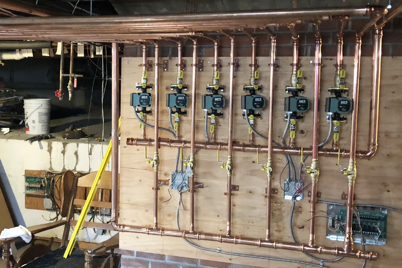 A Lochinvar high efficiency boiler system with copper piping professionally installed by Robies in a Cape Cod home, delivering reliable and energy efficient heating