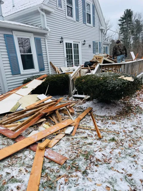 image of construction debris piled up on the back porch of a house before being removed