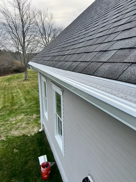 White New England home with full seamless white gutter run