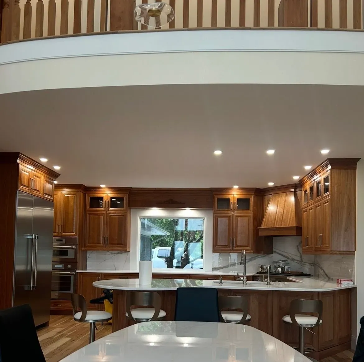 A kitchen with stainless steel appliances and wooden cabinets