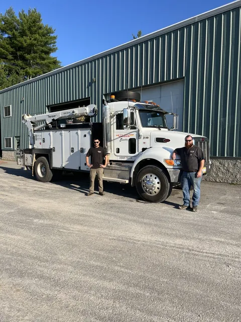 Rob and Will with the Woods service truck outside the shop in Gorham