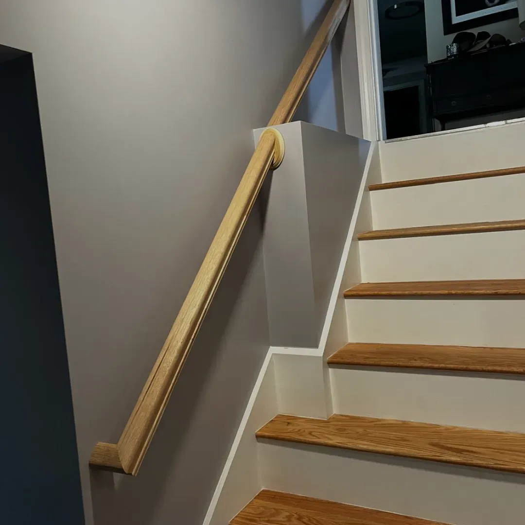 Custom oak handrail and stair installation by Tinbercraft Construction in Medford, MA