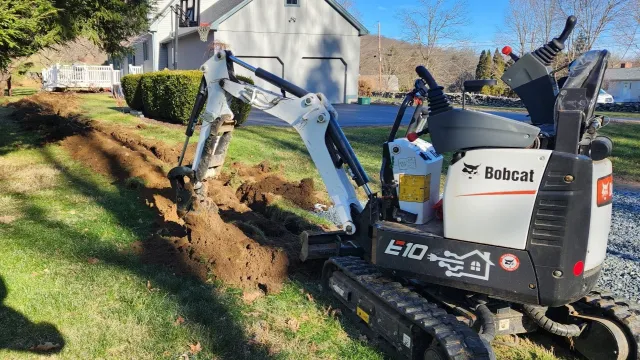 Electrician trenching shed power underground