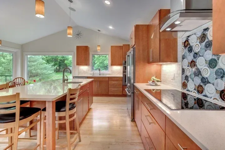 kitchen remodel featuring island seating and decorative tile backsplash by PEGASUS Design-to-Build in Lexington, MA