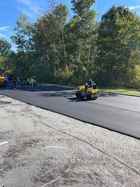 Asphalt paving crew with roller in southern Maine