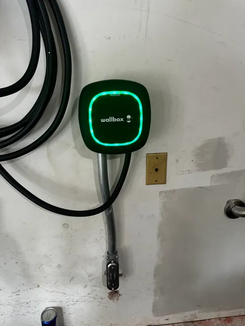 Wallbox Electric Vehicle Charger Installed on a Wall with Green Indicator Light