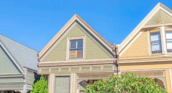 Homes with green, blue, and yellow exteriors