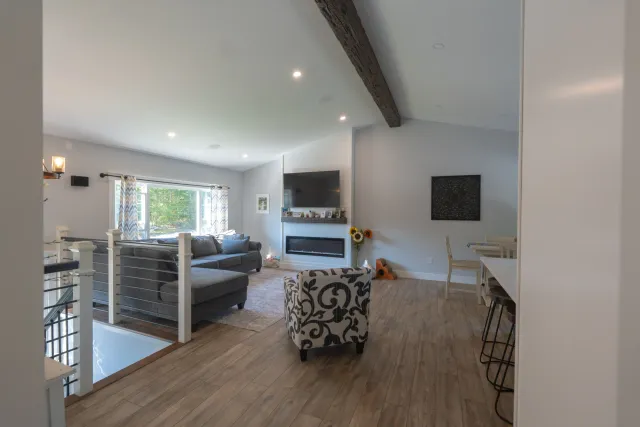Rebuilt vaulted living room with shiplap fireplace wall - Lucy Lane after