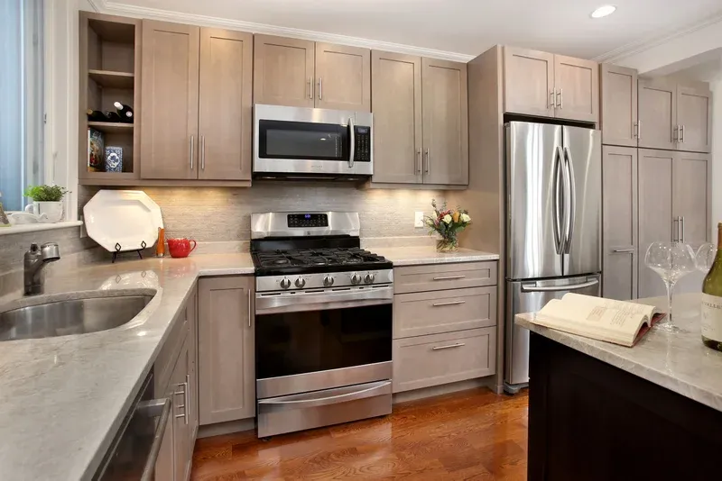 Kitchen with quartz counters, stainless appliances and open shelving