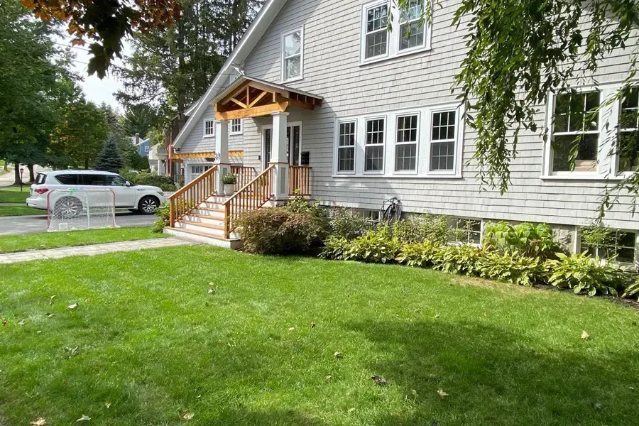 Green lawn and grey house.