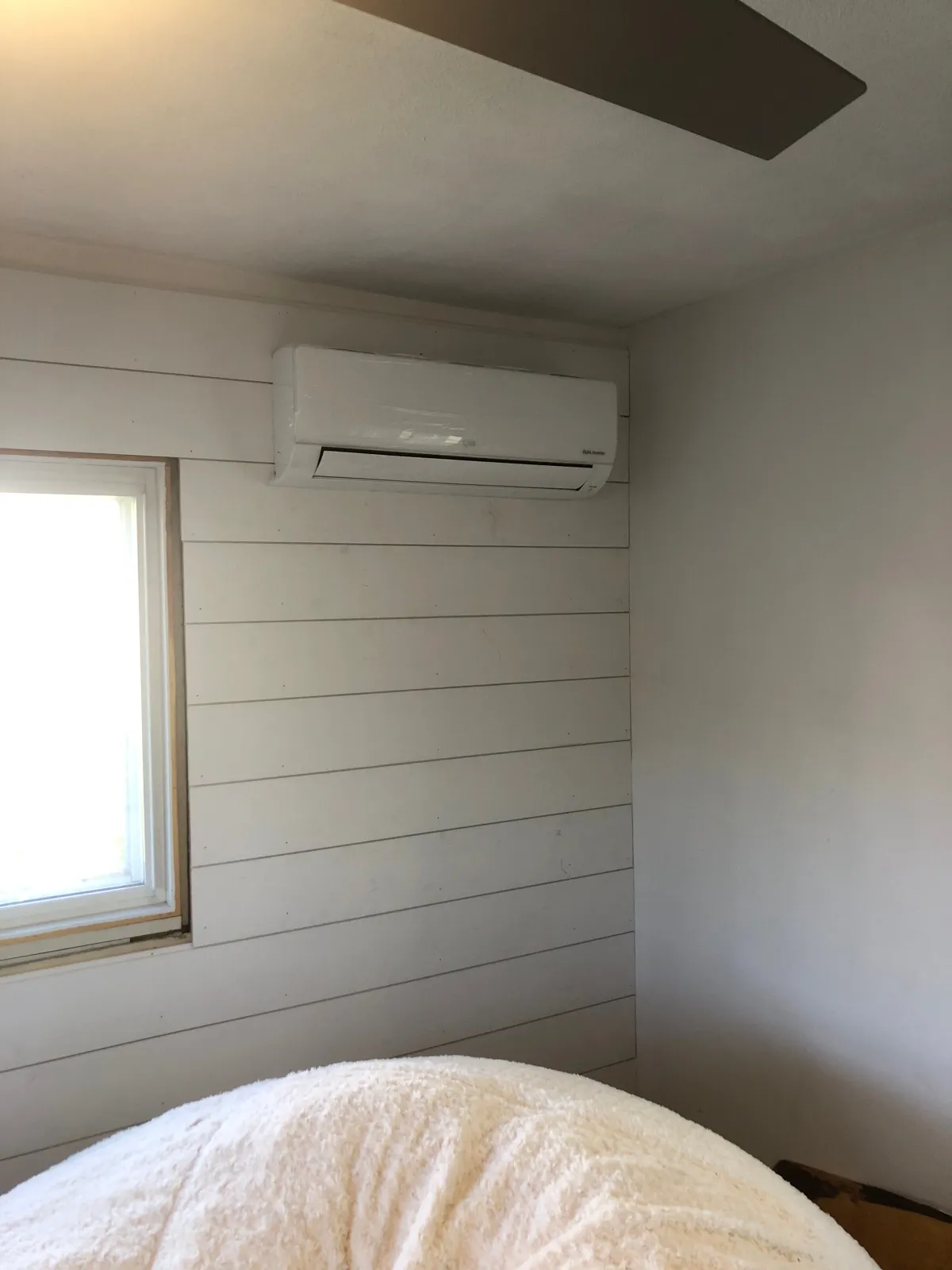Ductless mini-split head installed in a bedroom