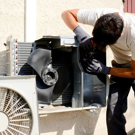 Technician repairing outdoor AC unit panel