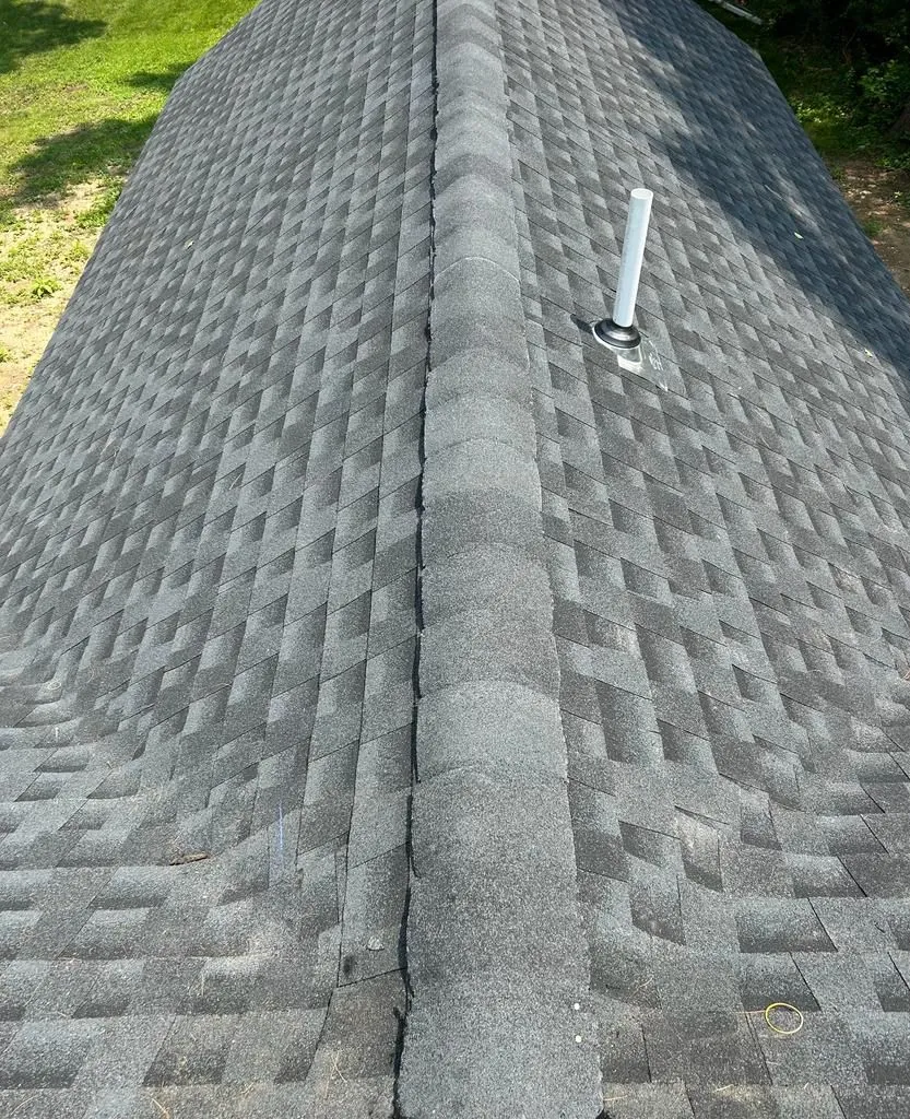 A close-up of a roof with a pipe on top of it.