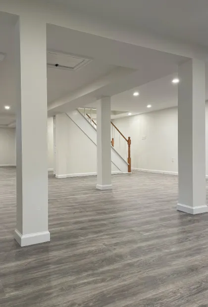 A room with white walls and wooden floors.