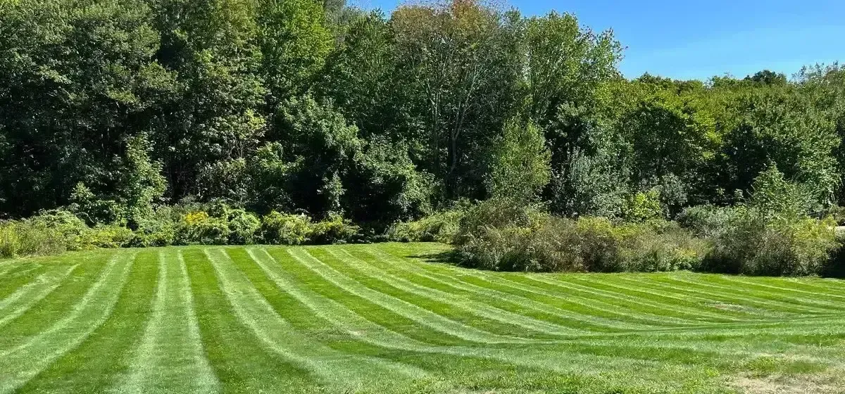 Landscape maintenance on a large mown property in Worcester County, MA by Funk Landscape & Design