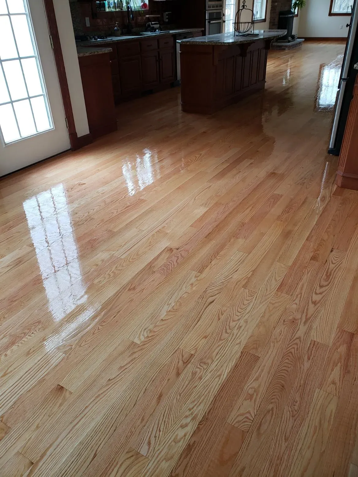 A kitchen with hardwood floors and a large island