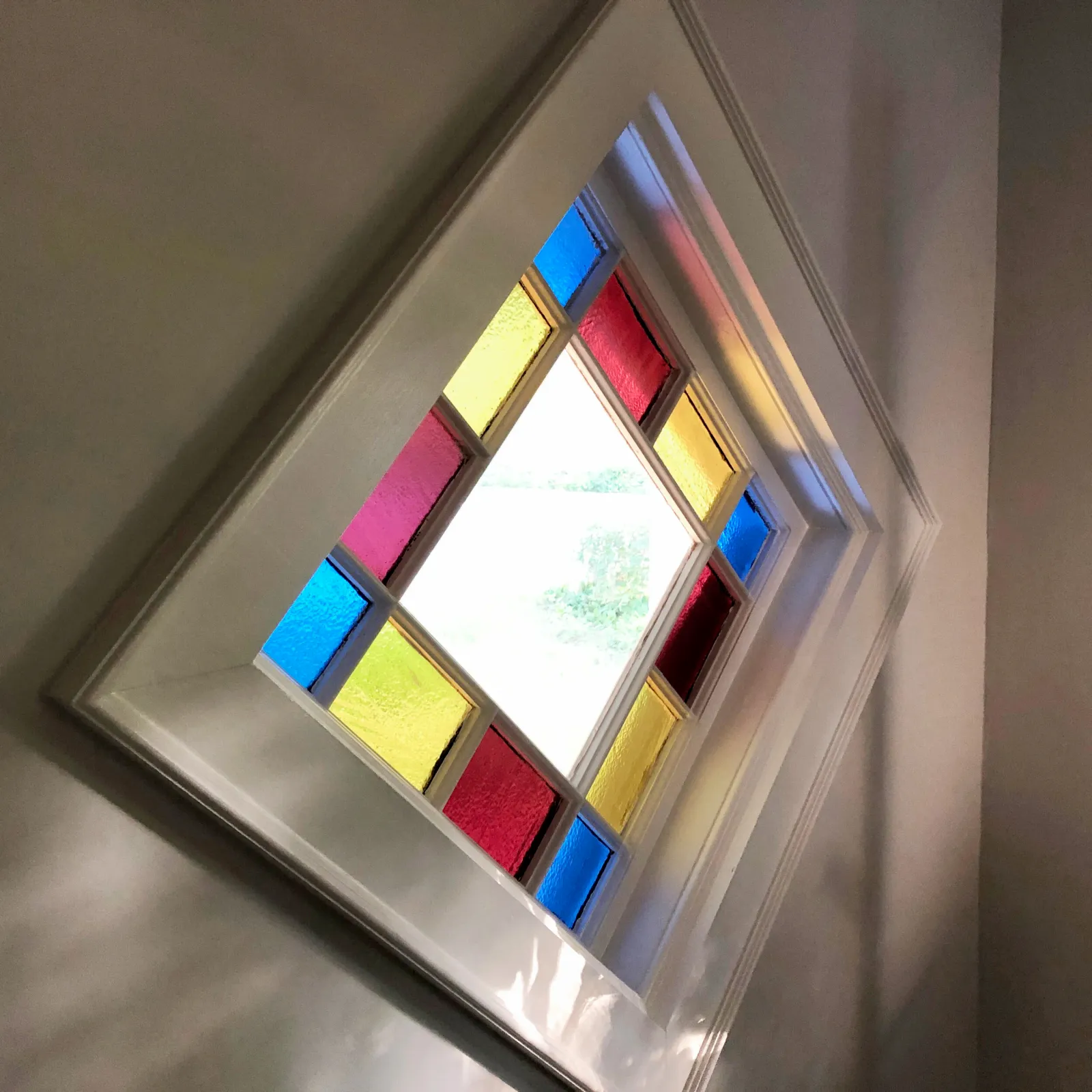 Custom molding to display an antique stained glass window