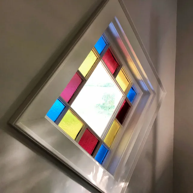 Custom molding to display an antique stained glass window