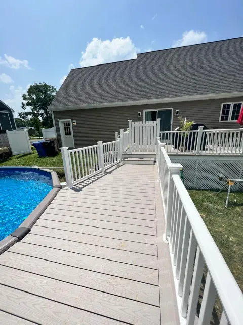 A house with a swimming pool and a deck leading to it