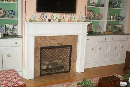A living room with a fireplace and a flat screen tv