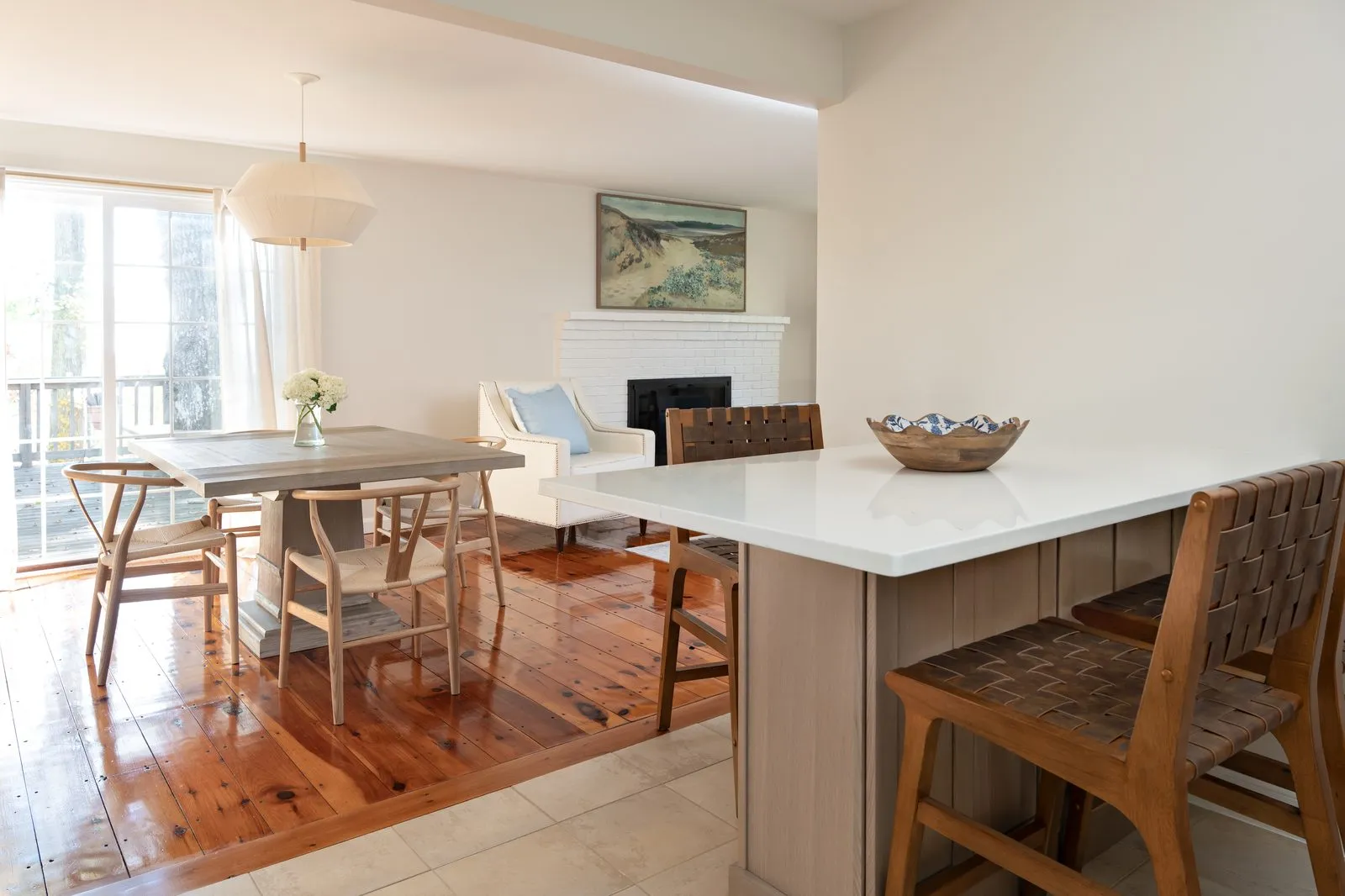 Indian Road open-plan kitchen and living area with original pine floors, fireplace, and coastal light