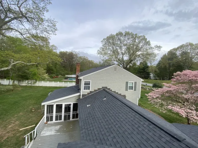 cream house with bluish gray roof