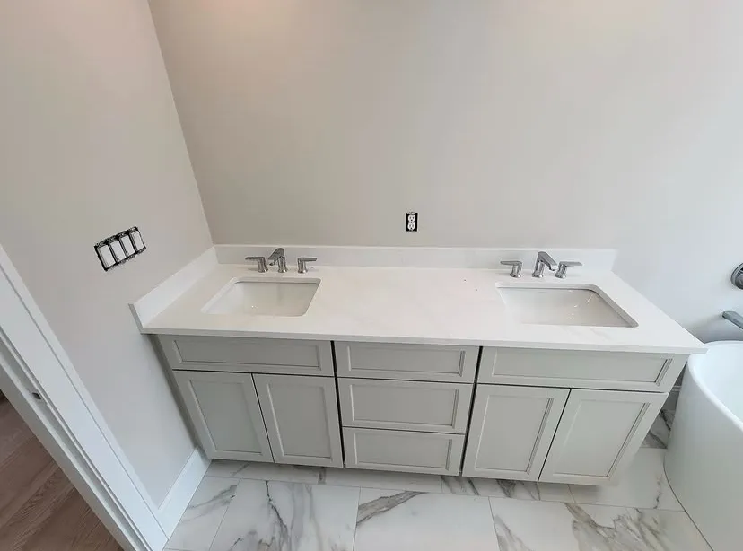 Double vanity with two sinks and chrome faucets installed by Aroso Plumber Methuen