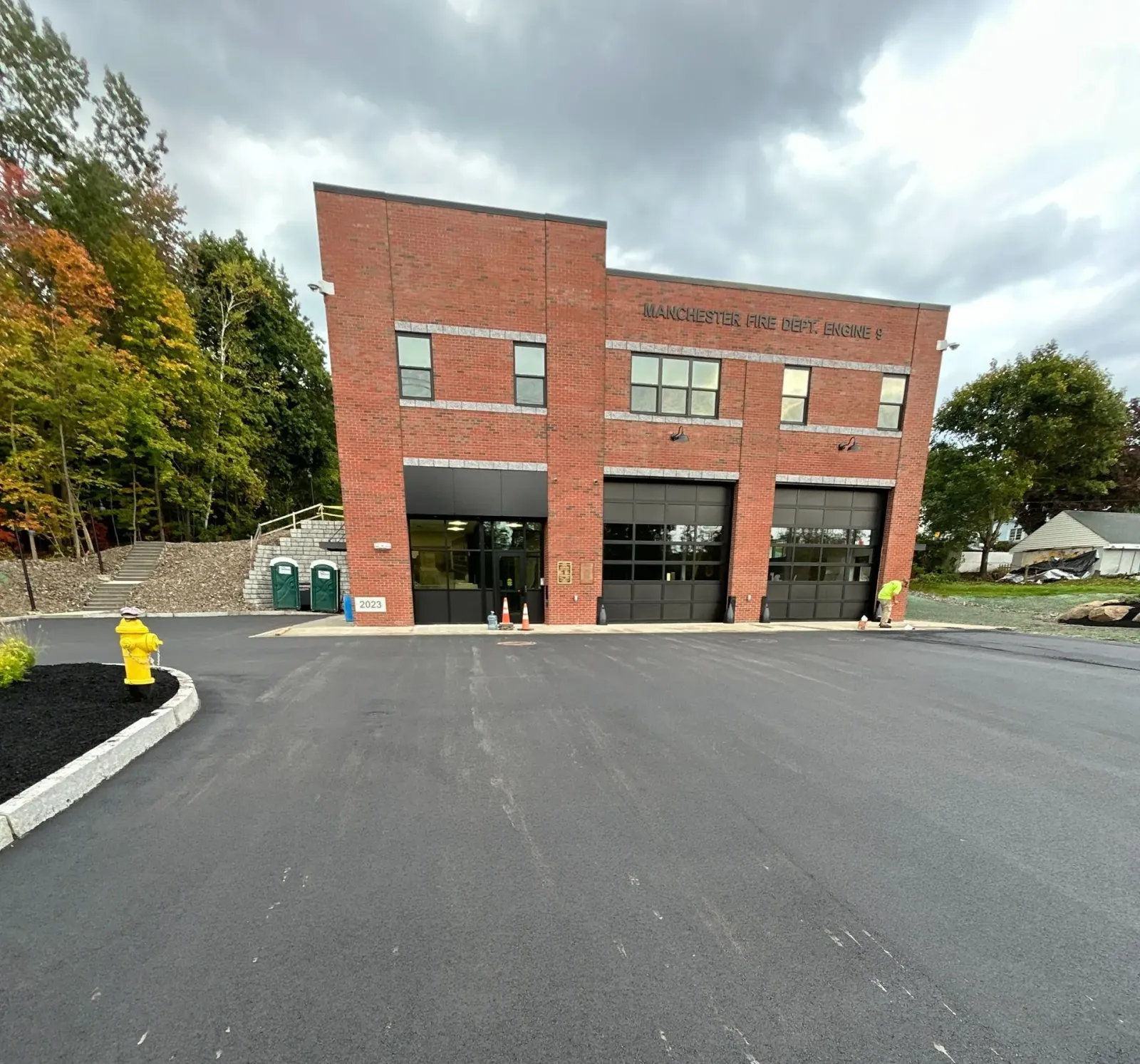 A large brick building with a parking lot in front of it.