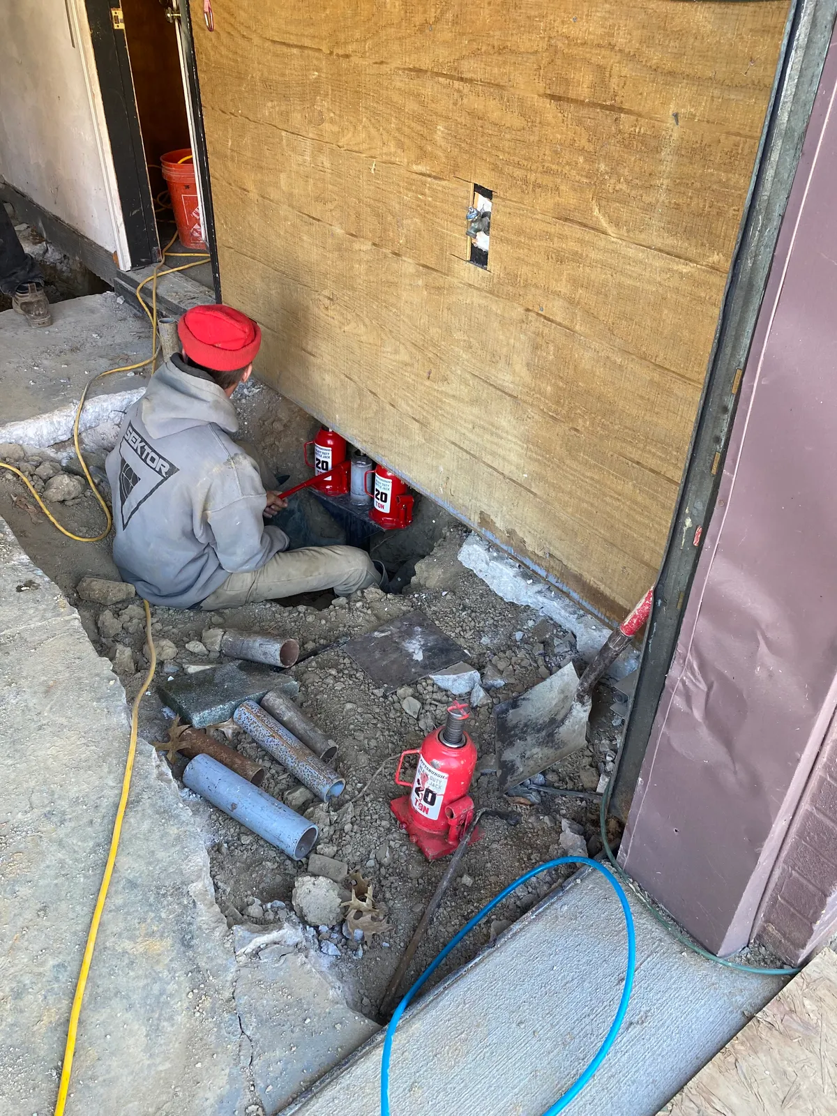 Queen Foundation Repair crew member working on a foundation repair project