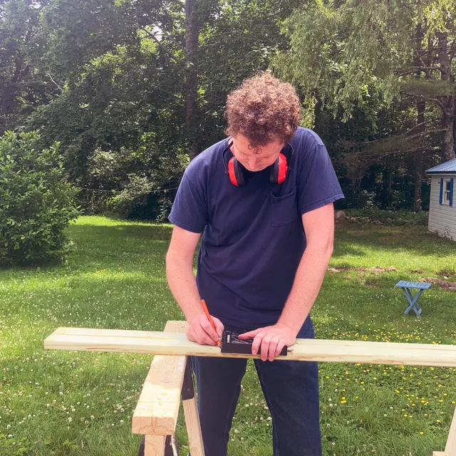 Henry measuring a board on site