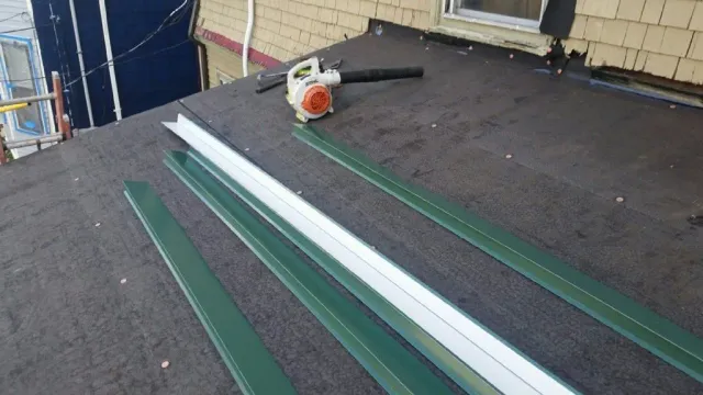 A blower is sitting on the roof of a house.