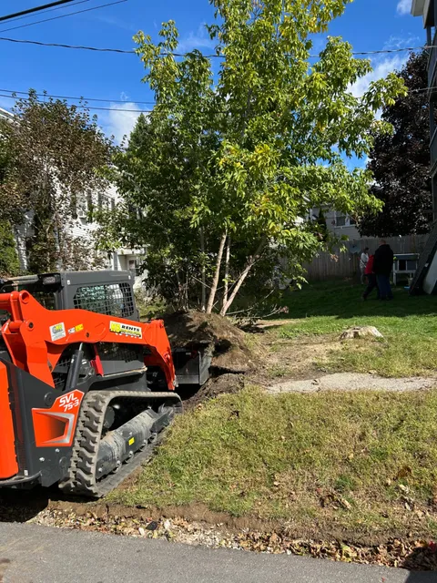 Track loader excavating a yard to prepare for a new driveway