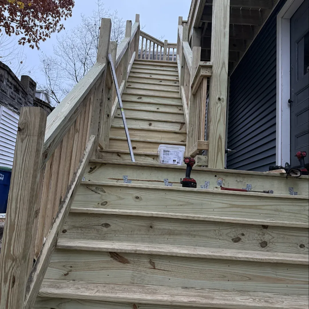 Pressure-treated exterior deck stairs and porch construction in Belmont, MA by Tinbercraft Construction