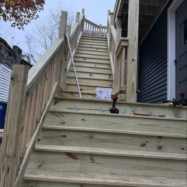 Pressure-treated exterior deck stairs and porch construction in Belmont, MA by Tinbercraft Construction