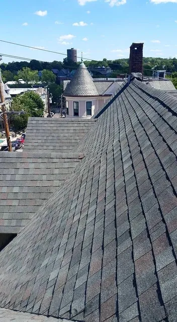 An aerial view of a roof with a city in the background.