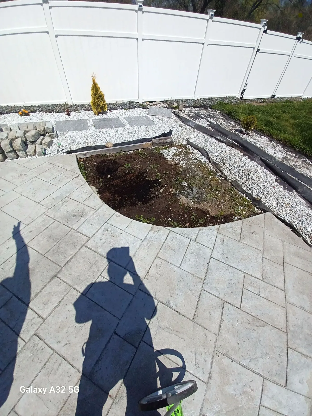Before: Paved patio with soil cutout