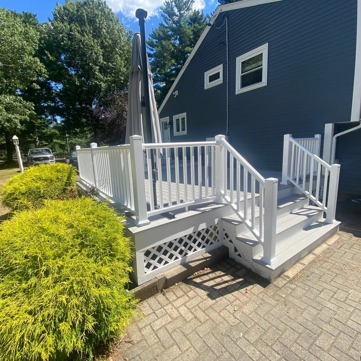 Deck landing and stairs against dark siding