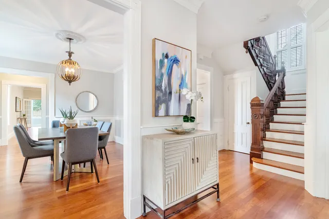 Entry hall and dining room with restored newel post and staircase
