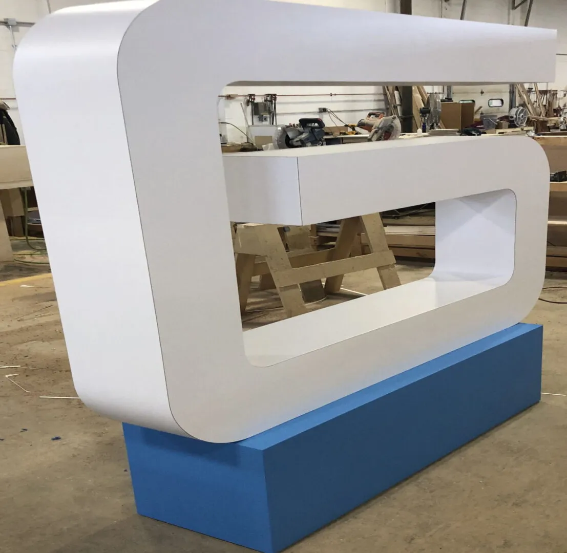 White geometric reception desk on blue base