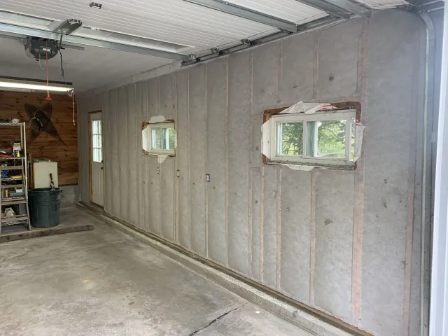 A house is being built with a vaulted ceiling and lots of windows.