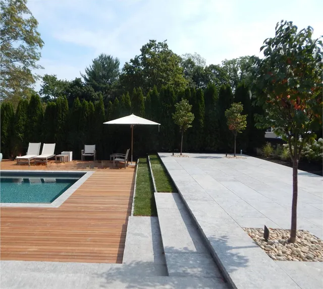Poolside patio with deck and privacy plantings