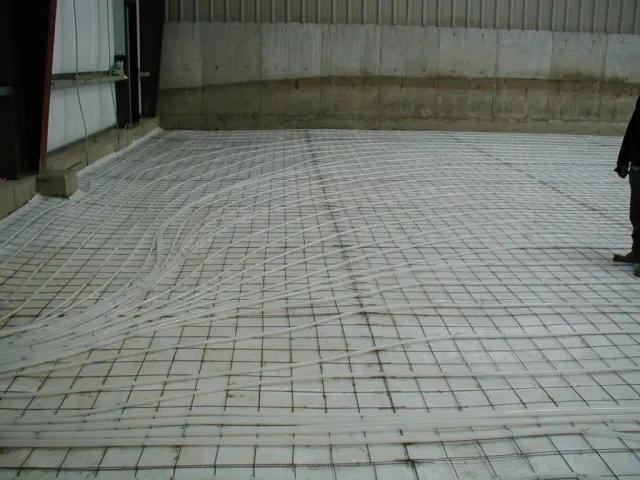 A person standing on a concrete floor with a grid pattern