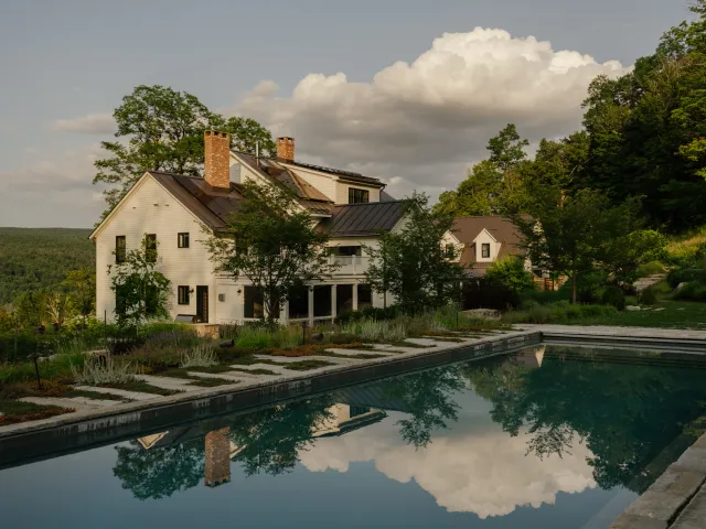 Natural stone pool terrace surrounded by richly planted gardens at Morningside