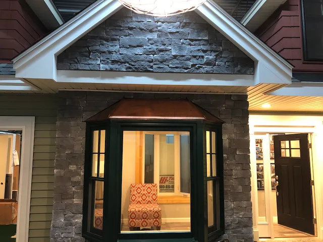 Showroom stone-front bay window and door display