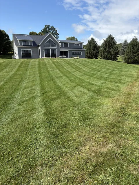 Freshly mowed and striped backyard lawn by L&D Property Maintenance
