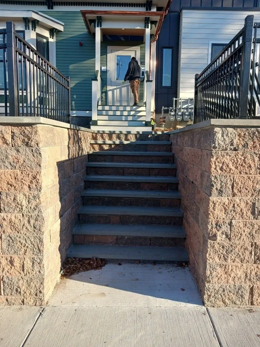 a set of stairs leading up to the front door of a house