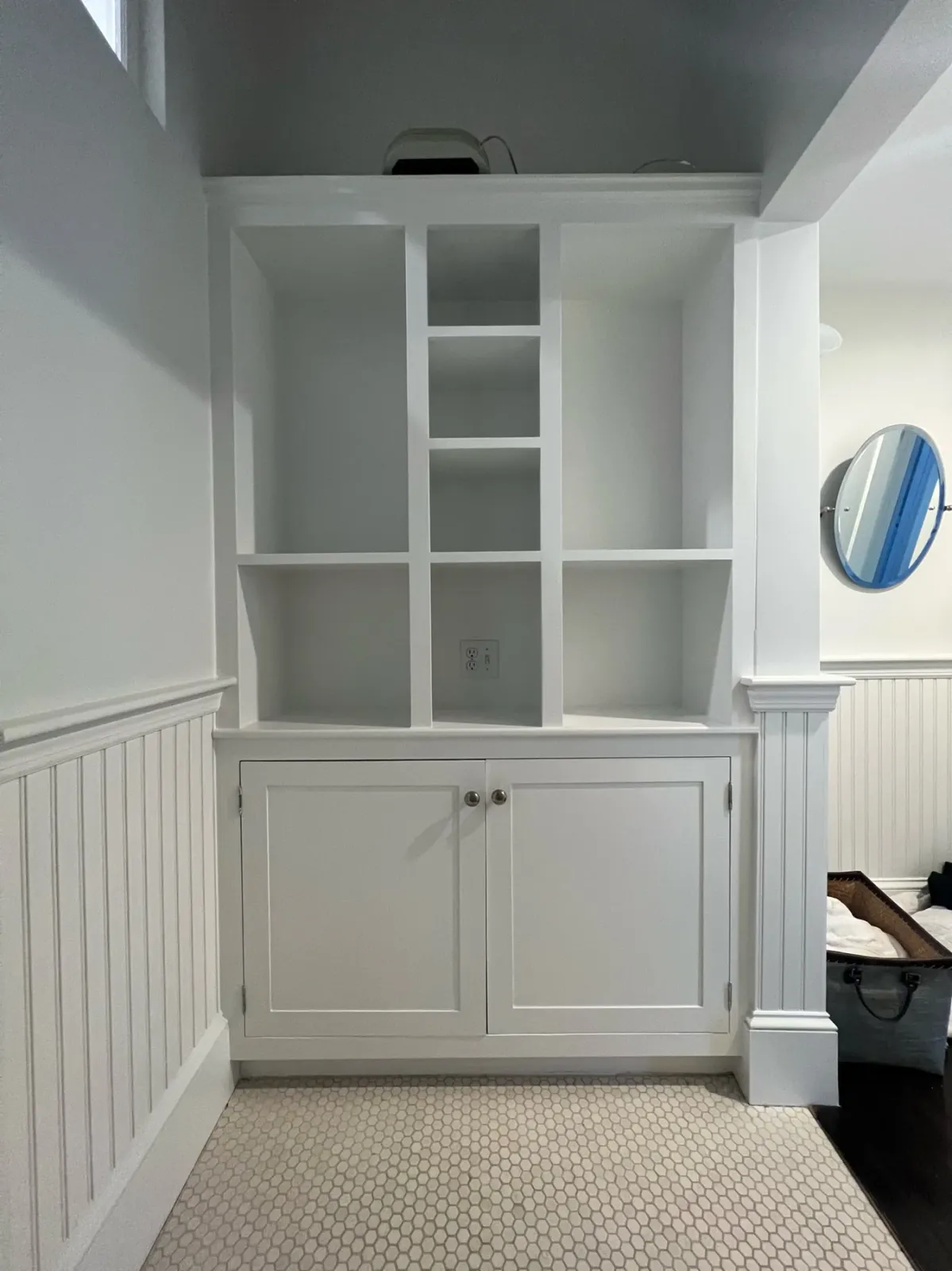 Freshly painted white built-in cabinetry and beadboard by Gallagher Painting