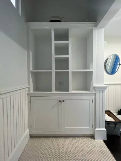 Freshly painted white built-in cabinetry and beadboard by Gallagher Painting