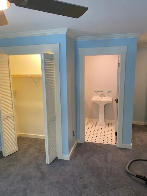 Blue residential bedroom with closet and half bath