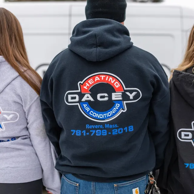 Dacey crew in branded workwear at the company van